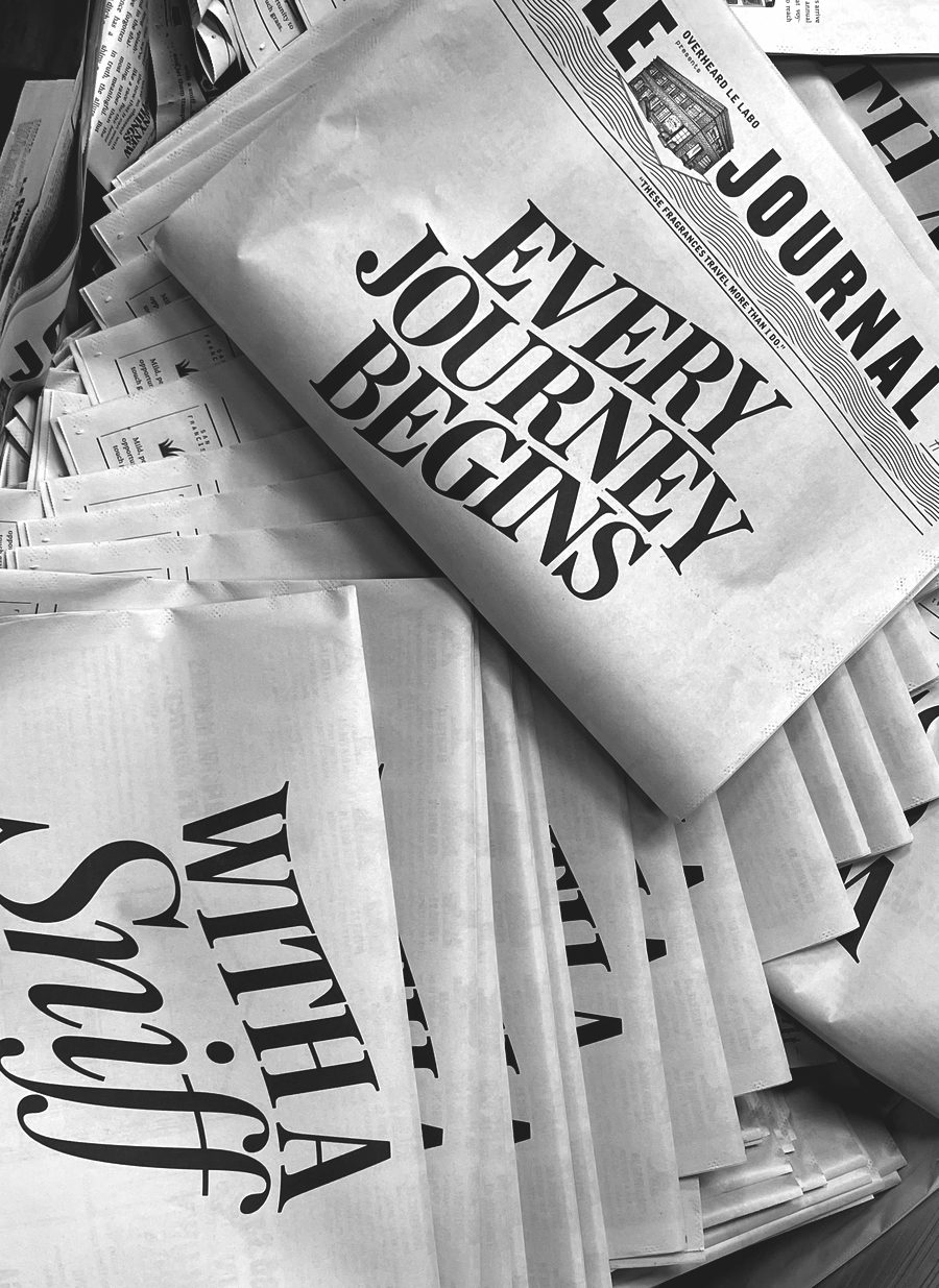 A stack of newspapers with the headlines 'Every Journey Begins' and 'With a Sniff'
